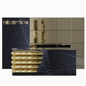 Reception desk is made of dark marble and gold metal